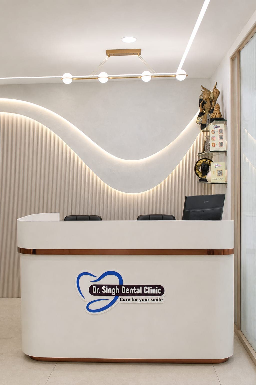 Dr. Singh Dental Clinic reception desk with backlit wave wall